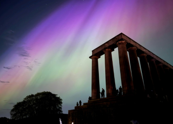 This handout photo taken and released by Jacob Anderson shows the northern lights, or aurora borealis, during a solar storm over the National Monument of Scotland in Edinburgh. ©AFP