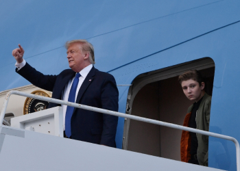 Former US president Donald Trump, pictured with son Barron in 2020, complained that he would be unable to attend the graduation ceremony -- but ultimately was granted a trial recess / ©AFP